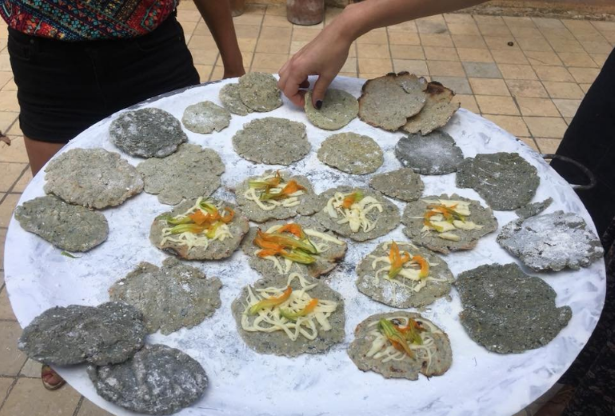 Tortilla making on traditional wood fired comal in Steps in San Cristobal de las Casas Mexico